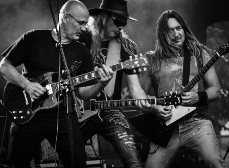 Canva - Group of Men Playing Guitar in Concert in Grayscale Photo